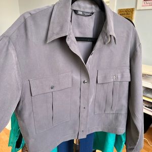 Gray soft material button up shirt.